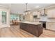 Modern kitchen featuring a large island, granite countertops, and stainless steel appliances at 40 Yellowstone Ct, Youngsville, NC 27596