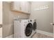 Convenient laundry room with washer, dryer, storage cabinets, and space for folding at 40 Yellowstone Ct, Youngsville, NC 27596