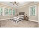 Spacious main bedroom with a tray ceiling, fan, carpet and lots of natural light at 40 Yellowstone Ct, Youngsville, NC 27596