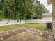 Well-maintained backyard featuring a brick patio, lush greenery, and a white picket fence, perfect for outdoor relaxation at 4020 Mindspring Dr, Raleigh, NC 27610