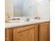 Bathroom vanity with a white countertop, wooden cabinets, and a modern silver faucet at 4020 Mindspring Dr, Raleigh, NC 27610