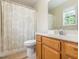 Cozy bathroom featuring a vanity with a white countertop and a shower with a patterned curtain at 4020 Mindspring Dr, Raleigh, NC 27610