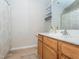 Bathroom featuring a vanity with a white countertop, wooden cabinets, and a shower with a patterned curtain at 4020 Mindspring Dr, Raleigh, NC 27610