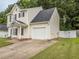 Charming two-story home with an attached garage and a manicured lawn, providing a welcoming curb appeal at 4020 Mindspring Dr, Raleigh, NC 27610