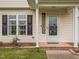 Inviting front porch with a 'WELCOME' sign, complemented by black shutters and a Ring security system at 4020 Mindspring Dr, Raleigh, NC 27610
