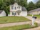 Charming two-story home featuring a manicured lawn, attached garage, and inviting curb appeal with a mailbox displaying '4020' at 4020 Mindspring Dr, Raleigh, NC 27610