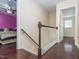 Hallway with dark wood floors and a staircase leading to bedrooms with bright-colored walls at 4020 Mindspring Dr, Raleigh, NC 27610