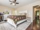 A well-lit primary bedroom with a white bed frame and neutral wall color at 4020 Mindspring Dr, Raleigh, NC 27610