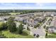 Aerial view of a community of two-story townhomes with manicured lawns and trees at 409 Rhamkatte Rd, Holly Springs, NC 27540