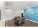 A dining area features a table with four chairs and a unique tree and bird decal on a light blue wall at 409 Rhamkatte Rd, Holly Springs, NC 27540