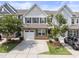 Charming townhouse with stone accents, a two-car garage, and a well-manicured front yard at 409 Rhamkatte Rd, Holly Springs, NC 27540