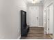 Welcoming foyer with wood floors, a coat rack, and ample natural light at 409 Rhamkatte Rd, Holly Springs, NC 27540