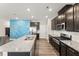 View of kitchen with granite countertop island, stainless appliances, and wood cabinets at 409 Rhamkatte Rd, Holly Springs, NC 27540