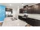 A kitchen with stainless steel appliances, dark wood cabinets, and granite countertops at 409 Rhamkatte Rd, Holly Springs, NC 27540