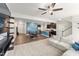 Bright open-concept living space features hardwood floors, a modern ceiling fan, and a kitchen with an island at 409 Rhamkatte Rd, Holly Springs, NC 27540