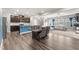 Open-concept living space featuring modern finishes, wood floors, and seamless flow between the rooms at 409 Rhamkatte Rd, Holly Springs, NC 27540