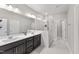 Bright main bathroom features double sinks, a glass-enclosed shower, and modern fixtures at 409 Rhamkatte Rd, Holly Springs, NC 27540