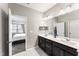 Well-lit main bathroom with a double vanity and tiled floors at 409 Rhamkatte Rd, Holly Springs, NC 27540
