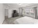 Spacious main bedroom features large windows, neutral paint, and a walk-in closet at 409 Rhamkatte Rd, Holly Springs, NC 27540