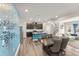 Open-concept floor plan featuring a dining area, kitchen, and living room with bright natural light at 409 Rhamkatte Rd, Holly Springs, NC 27540