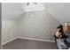 Finished attic with floral wallpaper and carpet at 4108 Lazyriver Ln, Durham, NC 27712