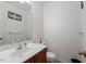 Half bathroom features sink, mirror, artwork and toilet with a trash bin next to it at 4108 Lazyriver Ln, Durham, NC 27712