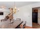 Charming dining area with a view of the kitchen, a decorative chandelier, and hardwood floors at 4108 Lazyriver Ln, Durham, NC 27712