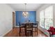 Bright dining room features a stylish chandelier, hardwood floors, and ample natural light, creating a welcoming ambiance at 4108 Lazyriver Ln, Durham, NC 27712