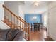 Open-concept featuring stairs, a dining area with hardwood floors and elegant chandelier, adjacent to a cozy living space at 4108 Lazyriver Ln, Durham, NC 27712
