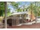 Two-story yellow home with rear deck, brick chimney, aluminum roof, and professional landscaping at 4108 Lazyriver Ln, Durham, NC 27712
