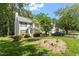 Traditional home with a manicured lawn, mature trees, and a driveway, providing a welcoming and established aesthetic at 4108 Lazyriver Ln, Durham, NC 27712