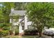 Charming two-story home with white siding, mature trees, manicured landscaping, and an inviting front entrance at 4108 Lazyriver Ln, Durham, NC 27712