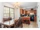 Eat-in kitchen with rich wood cabinetry, modern appliances, and a hanging chandelier at 4108 Lazyriver Ln, Durham, NC 27712