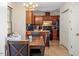 Kitchen-dining combo with wood cabinets, granite counters, tile floors, and modern appliances at 4108 Lazyriver Ln, Durham, NC 27712
