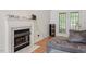 Living room featuring a fireplace, speakers and a door to the outside at 4108 Lazyriver Ln, Durham, NC 27712
