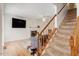 Inviting living room with stairs, a fireplace, and modern decor provides a cozy atmosphere for relaxation and entertainment at 4108 Lazyriver Ln, Durham, NC 27712