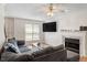 Living room featuring a fireplace, large TV and comfortable seating at 4108 Lazyriver Ln, Durham, NC 27712