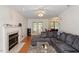 Comfortable living room with a fireplace, large couch, and natural light from the French doors at 4108 Lazyriver Ln, Durham, NC 27712