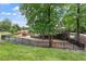 Community playground with slides, swings, and climbing structures surrounded by lush landscaping and green grass at 4108 Lazyriver Ln, Durham, NC 27712