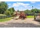 Community playground with slides, climbing equipment, swing and bench seating. Surrounded by a black fence at 4108 Lazyriver Ln, Durham, NC 27712