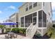 Exterior view of a house featuring a screened porch with a patio, picnic table and landscaped backyard at 4120 Overcup Oak Ln, Cary, NC 27519