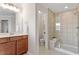 Bathroom featuring wood vanity, glass enclosed shower and toilet room at 4120 Overcup Oak Ln, Cary, NC 27519