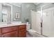 Bathroom featuring a vanity with sink, toilet, framed mirror and a glass-enclosed walk-in shower at 4120 Overcup Oak Ln, Cary, NC 27519