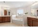 Bright bathroom features double vanity, soaking tub with tile surround, and window view at 4120 Overcup Oak Ln, Cary, NC 27519
