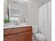 Bright bathroom featuring a single sink with a wooden vanity and a bathtub with a shower curtain at 4120 Overcup Oak Ln, Cary, NC 27519