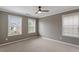 A carpeted bedroom features 3 windows at 4120 Overcup Oak Ln, Cary, NC 27519