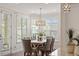 Dining room with a large table, seating for six, a stylish chandelier, and natural light at 4120 Overcup Oak Ln, Cary, NC 27519