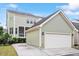 A house with a large, detached garage and a glimpse of a screened-in porch on the back, siding with nice lawn at 4120 Overcup Oak Ln, Cary, NC 27519