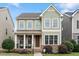 Charming two-story home featuring a welcoming front porch, well-maintained landscaping, and a mix of stone and siding accents at 4120 Overcup Oak Ln, Cary, NC 27519