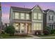 Beautiful two-story home with a charming front porch, landscaped yard, and a blend of siding and stone accents for texture at 4120 Overcup Oak Ln, Cary, NC 27519